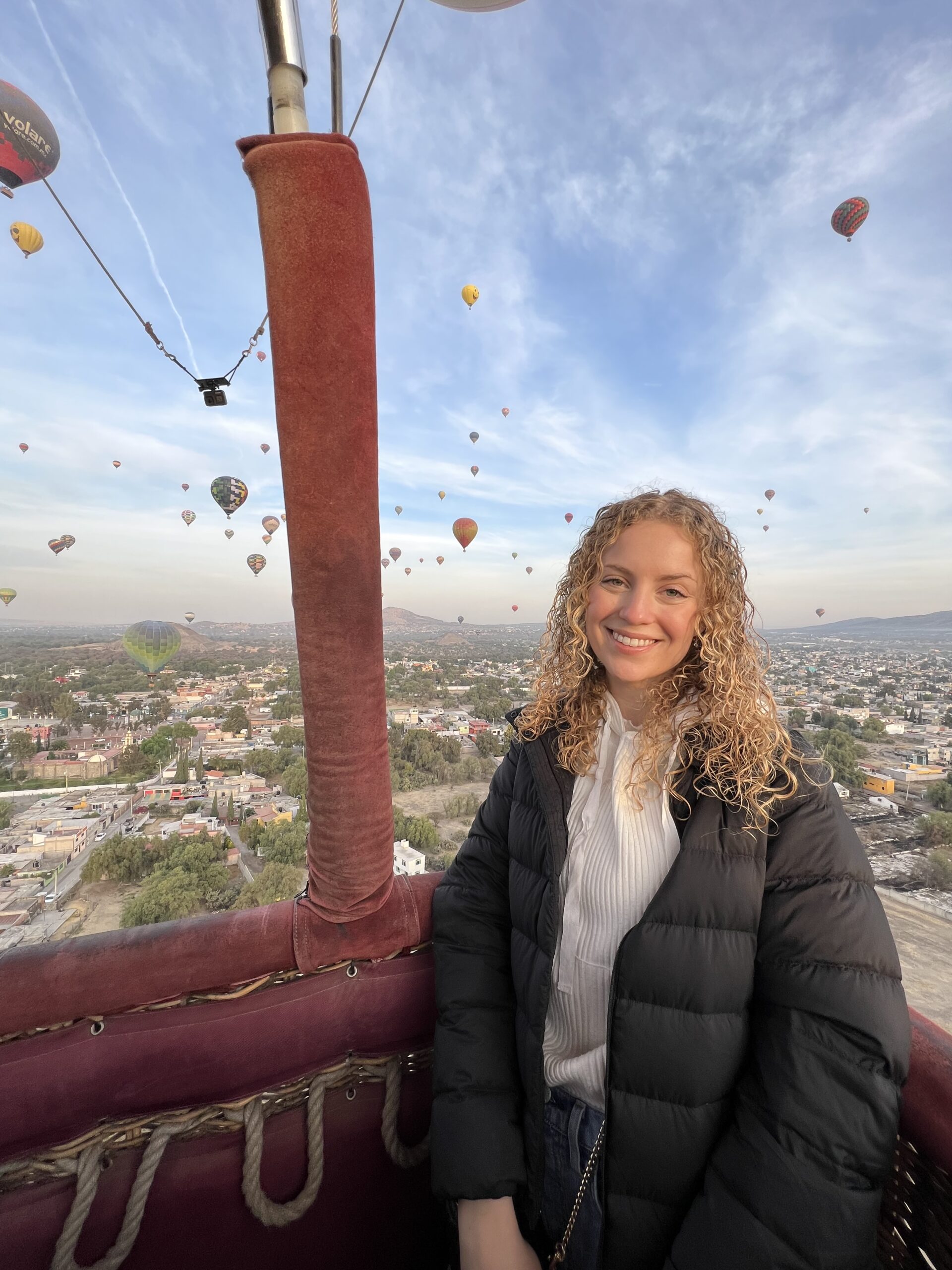 Genevieve, a young woman, sitting in a hot air balloon.
